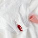 A menstrual cup alongside stained underwear on a clean towel, symbolizing menstrual health.